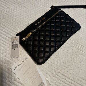Brand new never used Michael Kors clutch in Black.